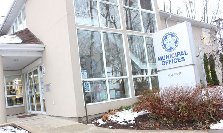 Beige office building with white sign out front with blue text stating Town Of Wasaga Beach Municipal Offices
