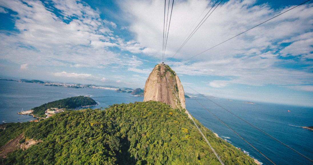 View of lush mountains and ocean from cable car attraction
