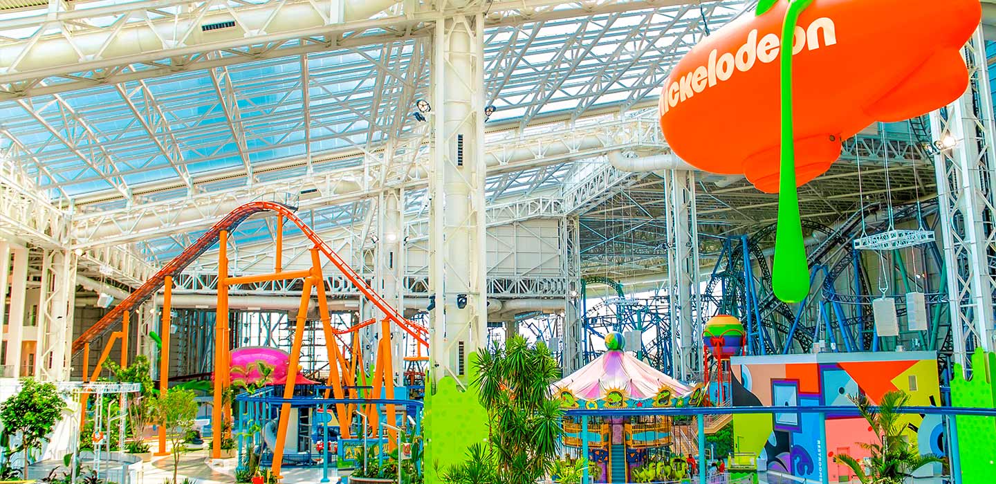 Nickelodeon Universe at American Dream side view of rollercoasters and orange nickelodeon blimp