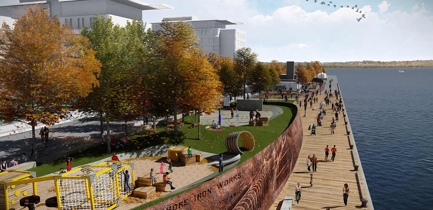 Waterfront boardwalk parkette with green and yellow trees, a park with children playing, and people walking