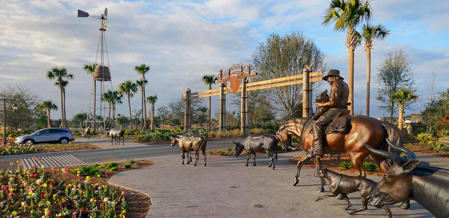 The Villages front gate with statue of a man on horseback with dog and goats