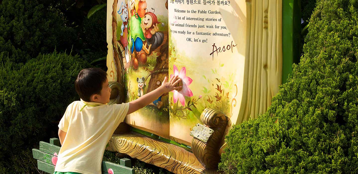 Boy touching giant story book page at Everland Theme Park