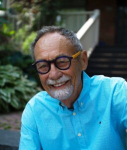 Portrait of Terry Brown in light blue button up shirt and black eye glasses